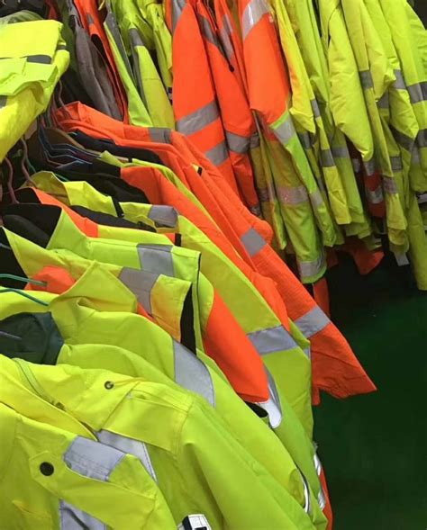 Rack of high-visibility orange and yellow safety jackets with reflective striping for Ohio construction crews