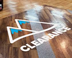 Custom floor graphic clearance decal on retail store hardwood floor
