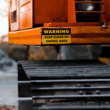 Large machinery industrial warning decal on construction equipment