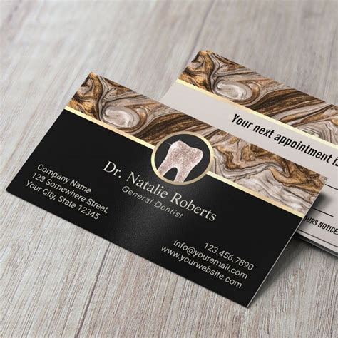 Elegant dental practice business card with gold tooth logo and marble accent design