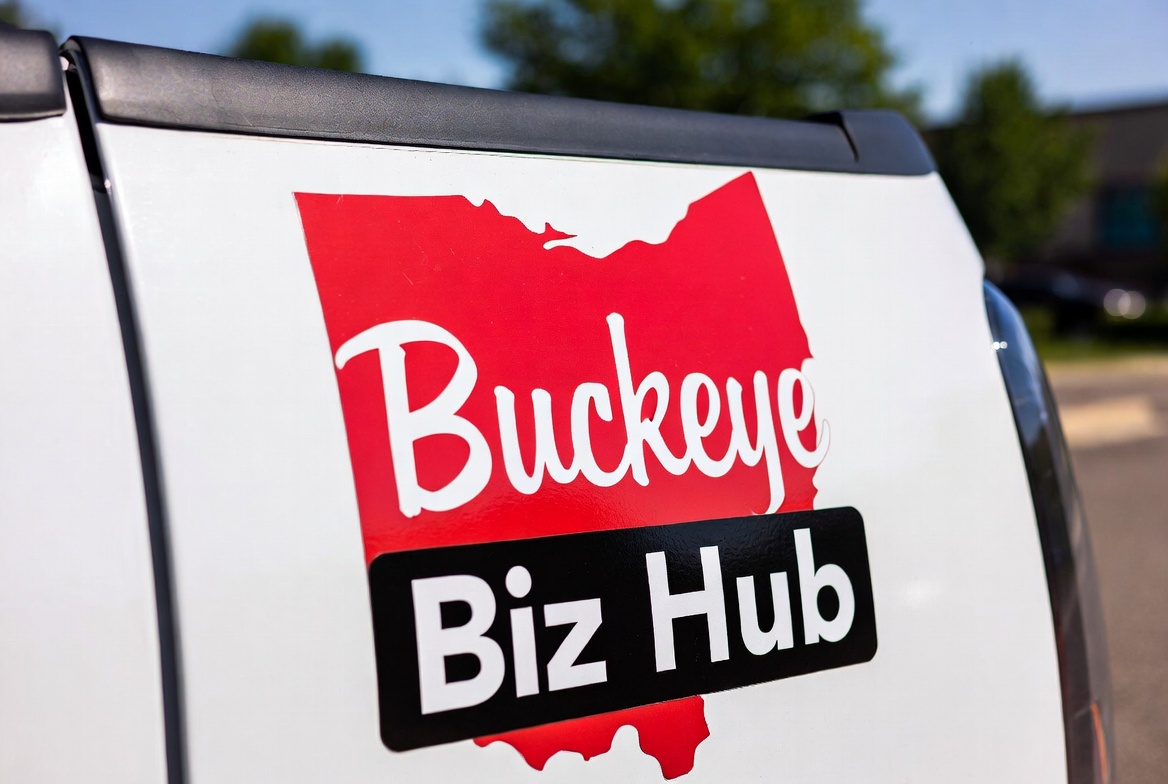 Red Ohio-shaped Buckeye Biz Hub logo with a black name bar on the white side of a vehicle