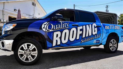 Full vehicle wrap on a blue roofing company truck with bold branding