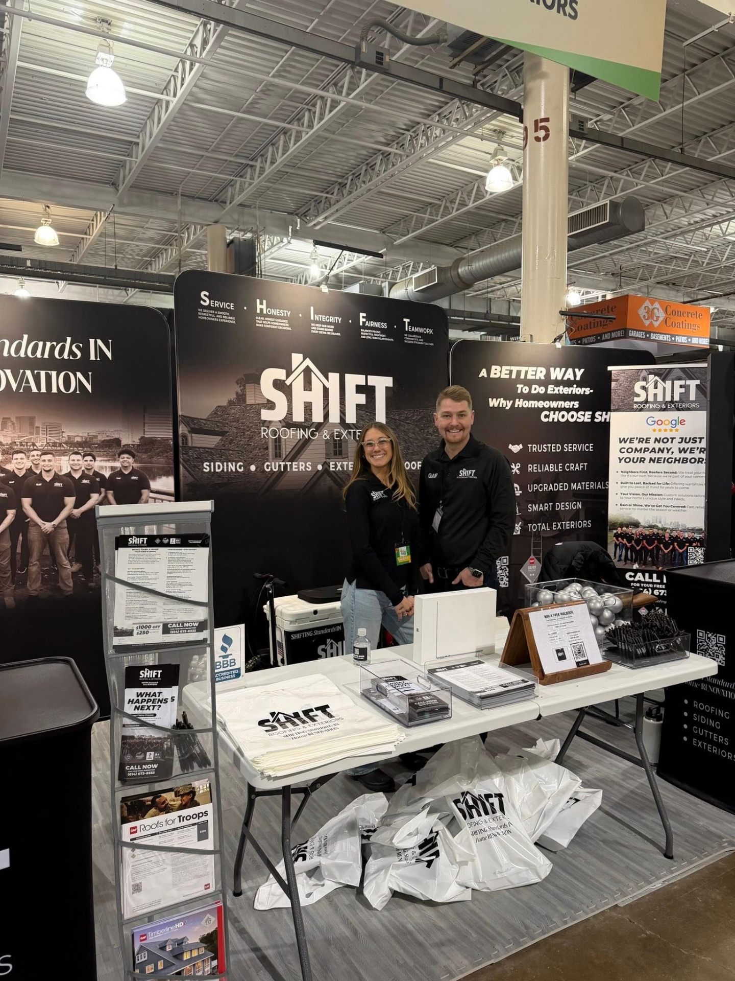 Construction company trade show booth with branded backdrop and retractable banners